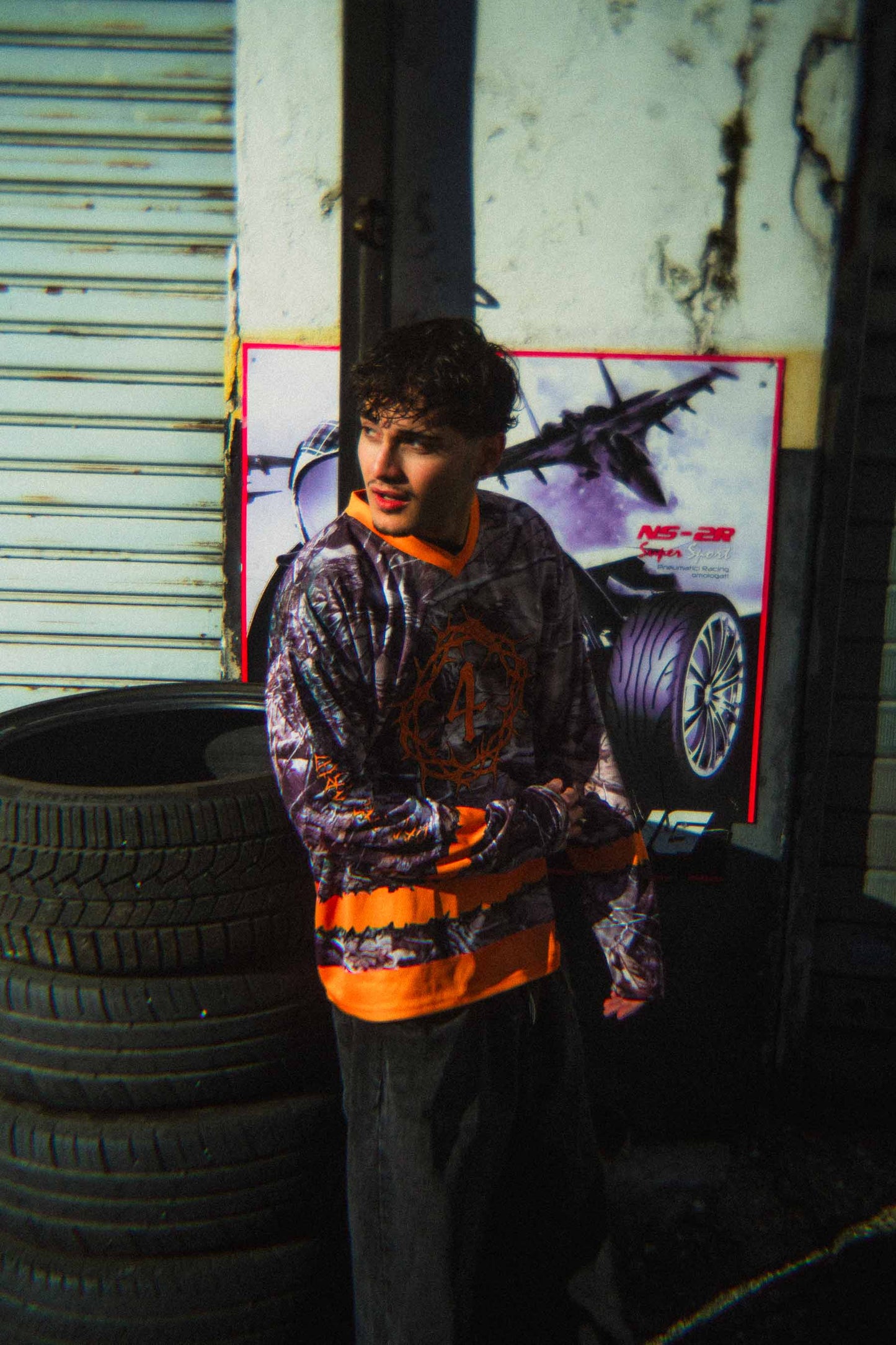 Model wearing the Off The Grid camouflage streetwear hockey jersey with baggy pants.