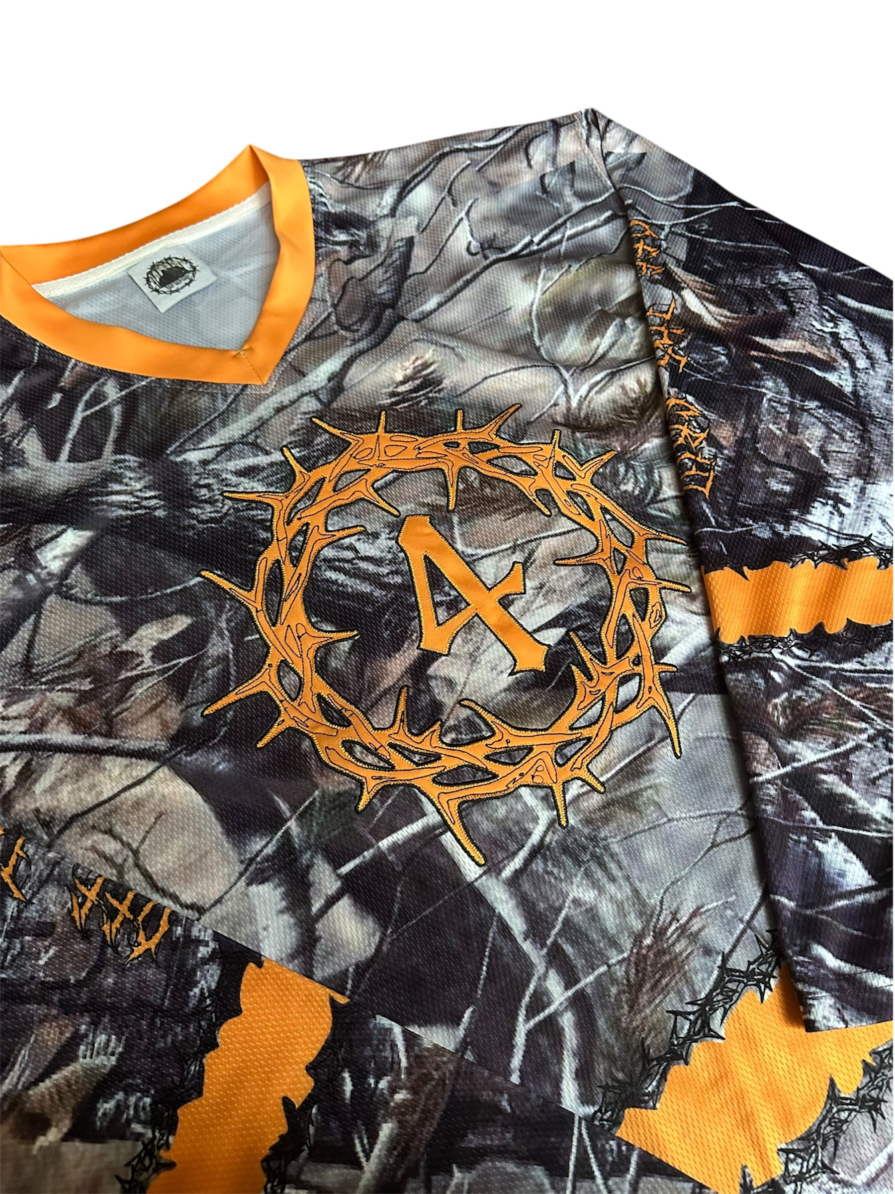Close-up of the premium mesh fabric, stitching, and V-neck collar of the Off The Grid jersey.